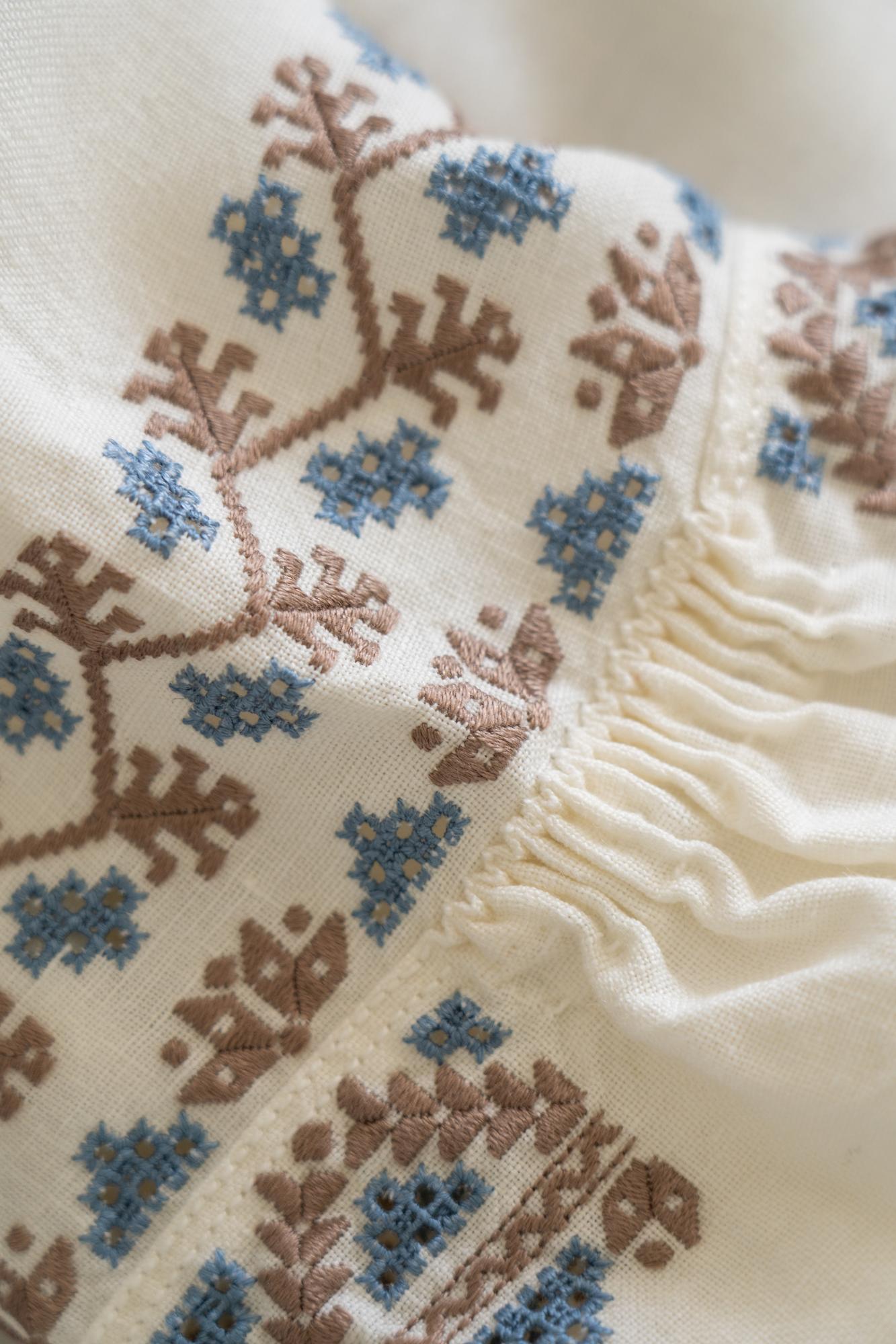 Close-up of embroidered floral motif on linen